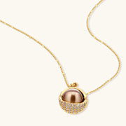 Gold-plated spherical jewelry set with zirconia crystals, featuring dome-shaped pendant and matching stud earrings.