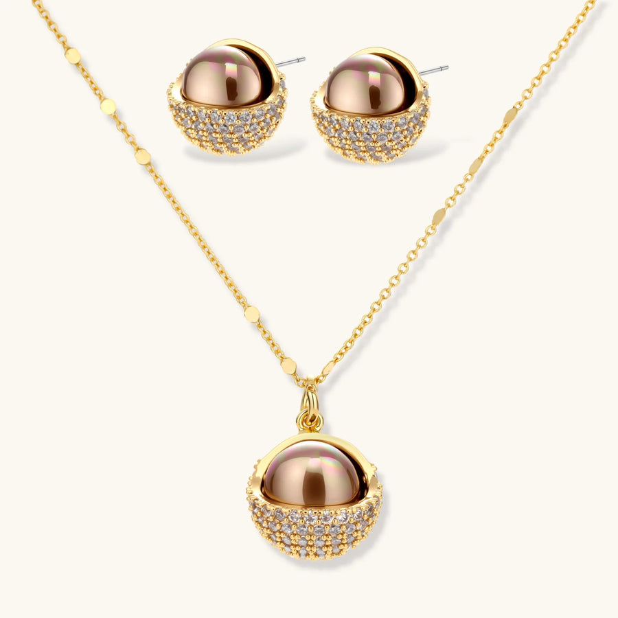 Gold-plated spherical jewelry set with zirconia crystals, featuring dome-shaped pendant and matching stud earrings.