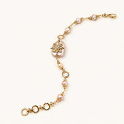 Gold-plated bracelet with pink baroque pearl centerpiece, floral connector, and freshwater pearls
