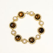Gold-plated link bracelet with alternating brown tiger's eye stones and white freshwater pearls in ornate bezels.