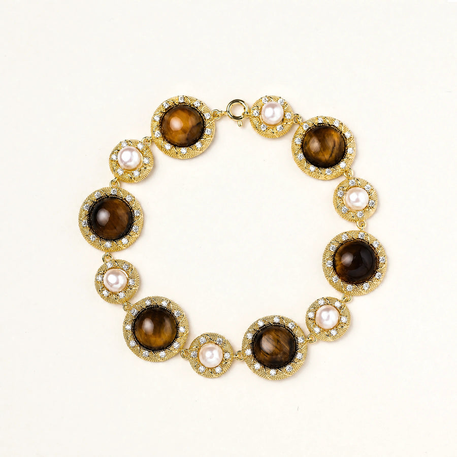 Gold-plated link bracelet with alternating brown tiger's eye stones and white freshwater pearls in ornate bezels.