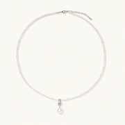 Dainty necklace with lavender crystal beads, freshwater pearls, geometric pendant, and large pearl drop on white background.