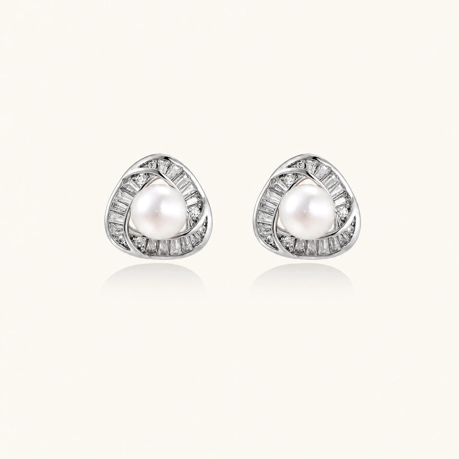 Triangular white gold plated stud earrings with central freshwater pearl and baguette-cut stones on white background