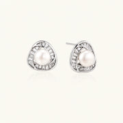Triangular white gold plated stud earrings with central freshwater pearl and baguette-cut stones on white background