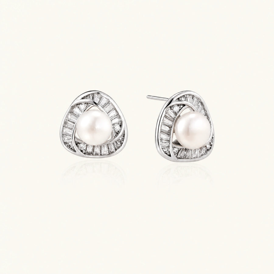 Triangular white gold plated stud earrings with central freshwater pearl and baguette-cut stones on white background