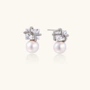 White gold stud earrings with square crystal stones in twisted frames and pink freshwater pearl drops below