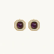 Gold-plated octagonal stud earrings with burgundy liuli centers and cubic zirconia halos on white background