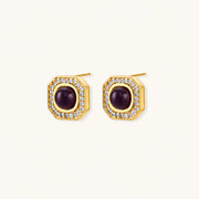 Gold-plated octagonal stud earrings with burgundy liuli centers and cubic zirconia halos on white background