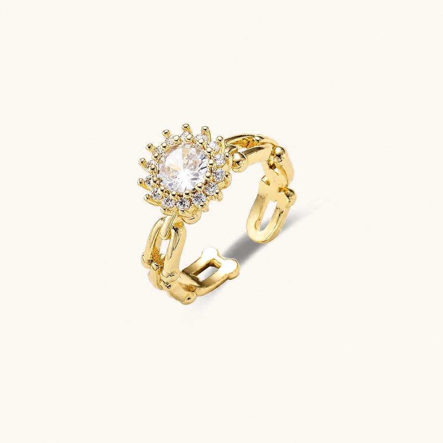 Two adjustable gold rings: chain-link band and halo-style ring with cubic zirconia stones on cream background