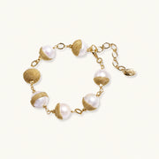 Adjustable bracelet with baroque pearls wrapped in delicate gold mesh netting connected by textured chain links
