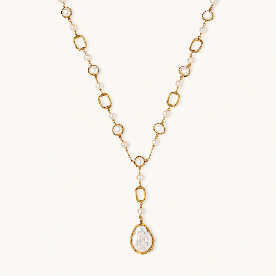 Long gold-plated necklace with alternating freshwater pearls and crystal bezels, featuring a large baroque pearl pendant