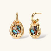 Gold-plated convertible hoop earrings with iridescent shell mosaic pendants, shown assembled and separated on cream background.