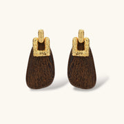 Elegant drop earrings featuring intricate 18k gold plated copper metalwork with dark brown wooden teardrop pendants