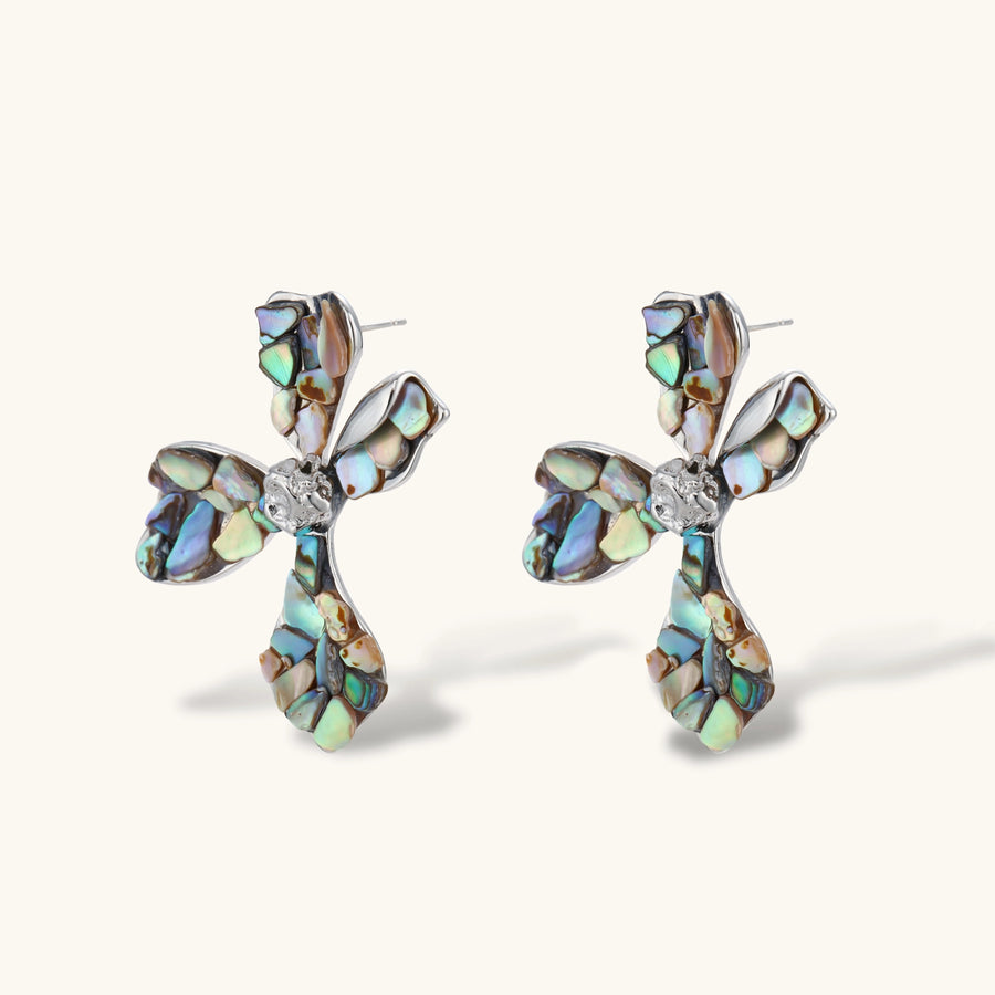 Pair of oversized four-petal flower stud earrings with iridescent teal and blush shell mosaic on silver-tone petals.